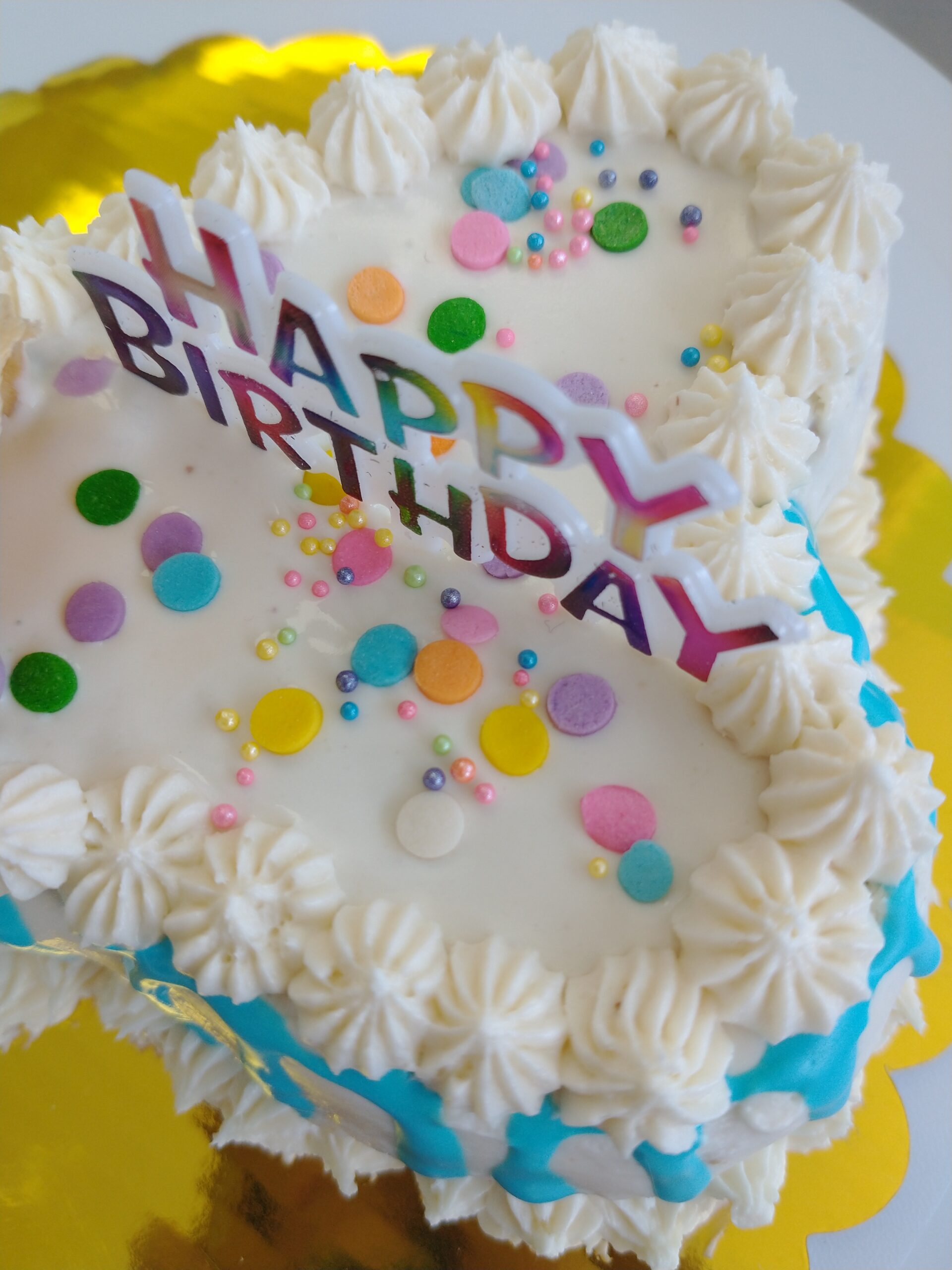 Custom large dog birthday cake in the shape of a bone in this closeup